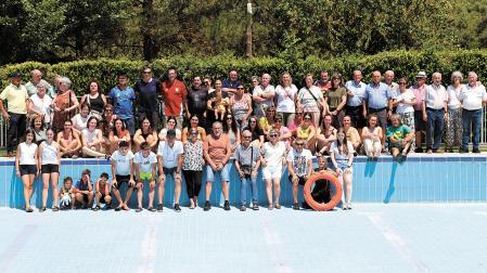 Vecinos de distintas generaciones posan en la piscina de su pueblo, Igúzquiza, vacía para su pesar este verano