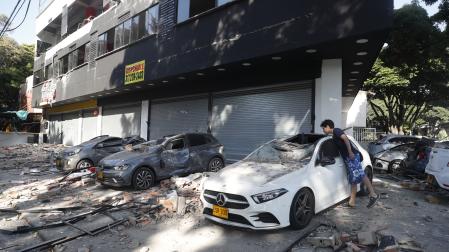 n hombre observa un vehículo afectado tras un fuerte temblor este lunes, en Cali (Colombia)