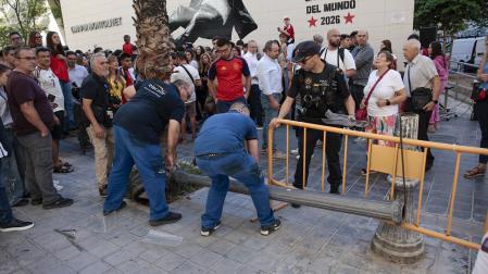 Operarios, junto a la farola caída