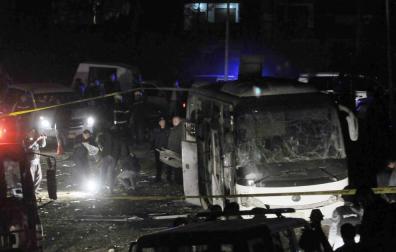 Miembros de los cuerpos de seguridad egipcios inspeccionan los daños causados por un atentado bomba junto a las pirámides de Guiza.