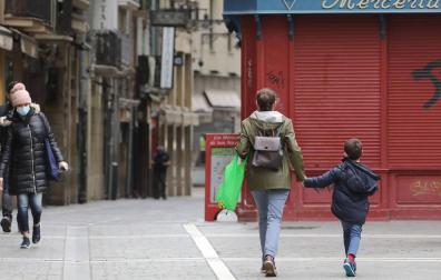 Un niño, acompañado, en el Casco Antiguo de Pamplona.