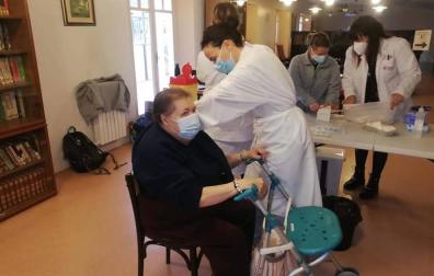 Una mujer recibe la primera dosis de la vacuna en la Misericordia de Tudela.