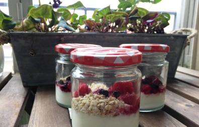 Imagen de los yogures con los frutos del bosque presentados bonitos.