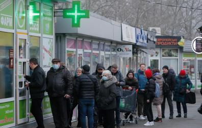 Ciudadanos ucranianos esperan para entrar a una farmacia en Kiev