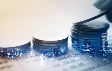 Double exposure of city and rows of coins for finance and banking concept