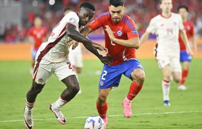 El canadiense Richie Laryea (izda.) trata de marcharse del chileno Gabriel Suazo, que fue expulsado, en un momento del encuentro