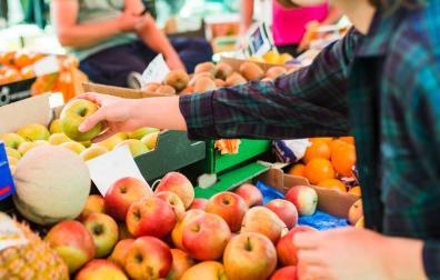 Una mujer, comprando fruta en una tienda