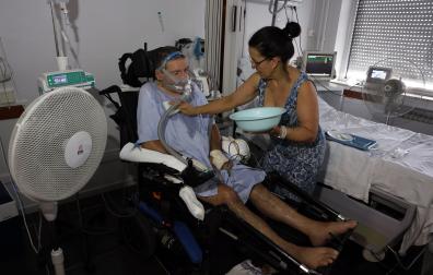 María García refresca a su marido en la habitación que ocupan en el hospital