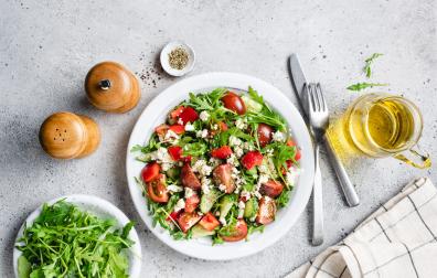 Healthy vegetable salad with arugula, tomatoes and goats cheese