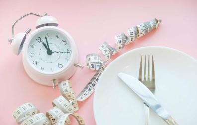 Time to lose weight , eating control or time to diet concept , alarm clock with healthy tool concept decoration on blue background