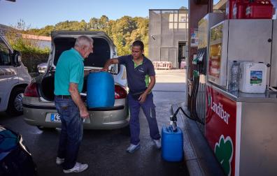 Un ciudadano francés rellena garrafas con gasóleo tras llenar el depósito de su coche en Dantxarinea