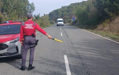 Un agente de Policía Foral señaliza un incidente vial en la NA1110