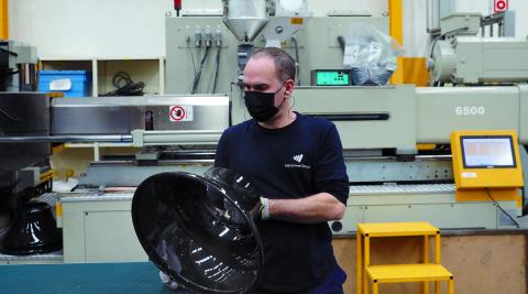 Un trabajador maneja una parte de la luminaria de ATP Un trabajador maneja una parte de la luminaria de ATP