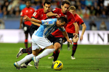 Imágenes del encuentro entre Osasuna y Málaga, disputado este domingo en el estadio de la Rosaleda.