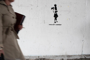 Grafitis de similar estética a la del famoso grafitero internacional Banksy decoran las paredes del tunel que une la calle Esquiroz con la Universidad de Navarra