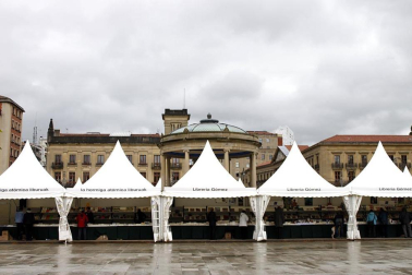 Mal tiempo en la inauguración de la XII Feria del Libro de Pamplona, con los visitantes acudiendo a los puestos de la Plaza del Castillo.
