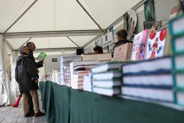 Mal tiempo en la inauguración de la XII Feria del Libro de Pamplona, con los visitantes acudiendo a los puestos de la Plaza del Castillo.