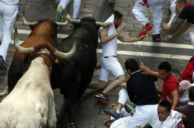 Imágenes del séptimo encierro de los Sanfermines 2019 protagonizado por toros de La Palmosilla.