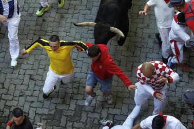 Los mozos conducen a los toros de La Palmosilla a la plaza en el tramo del callejón