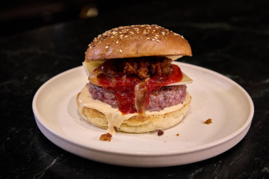Obra de los creadores de contenido gastronómico de Navarra, Foodie Team. Carne con queso del Roncal, mayonesa trufada, mermelada de pimientos piquillos, cebolla flambeada con pacharán y chistorra crujiente.