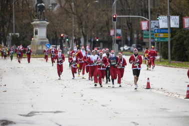 Participantes de todas las edades recorren el centro de Madrid vestidos de papá noeles durante la 14ª edición de la Carrera de Papá Noel, este domingo 21 de diciembre