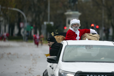 Participantes de todas las edades recorren el centro de Madrid vestidos de papá noeles durante la 14ª edición de la Carrera de Papá Noel, este domingo 21 de diciembre