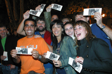 Varios espectadores muestran su entrada antes de acceder al recinto pamplonés