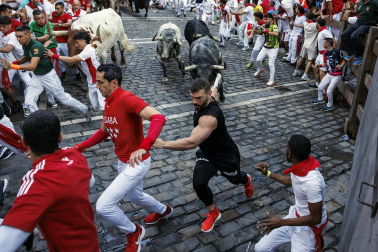 Segundo encierro de San Fermín 2026 con toros de Cebada Gago en la curva de Mercaderes.