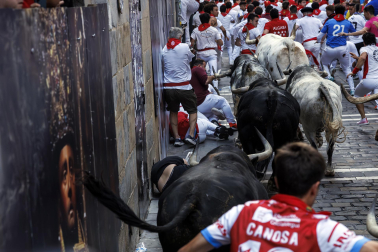 Segundo encierro de San Fermín 2026 con toros de Cebada Gago en la curva de Mercaderes.