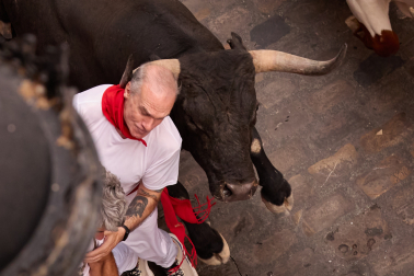Fotos del séptimo encierro de San Fermín 2026 con toros de Miura en la cuesta de Santo Domingo.