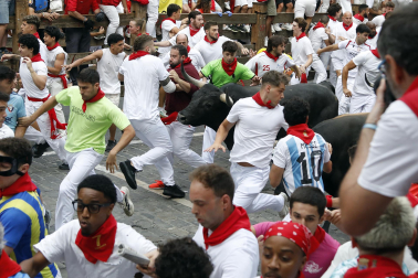 Fotos del séptimo encierro de San Fermín 2026 con toros de Miura en la curva de Telefónica.