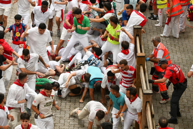 Fotos del séptimo encierro de San Fermín 2026 con toros de Miura en la bajada al callejón.