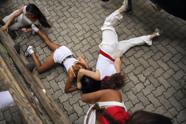 Fotos del séptimo encierro de San Fermín 2026 con toros de Miura en la bajada al callejón.