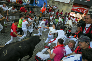Fotos del octavo encierro de San Fermín 2026 con toros de la ganadería de Jandilla en la bajada al callejón.