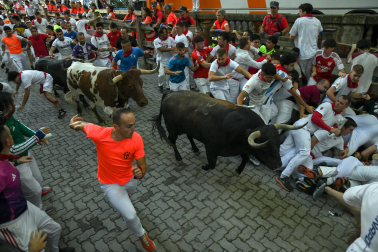 Fotos del octavo encierro de San Fermín 2026 con toros de la ganadería de Jandilla en la bajada al callejón.