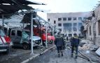 Personal de rescate camina junto a los vehículos destruidos en un complejo de un depósito de bomberos del Servicio Estatal de Emergencia gravemente dañado por un ataque con misiles rusos, en Dnipro