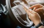 Una persona con un móvil al volante