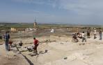 Varios de los participantes en la excavación trabajan en la zona que se ha elegido este año. Al fondo se ve la torre de la iglesia de Valtierra