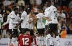 Abde, sentado en el suelo, ve cómo los jugadores del Valencia celebran su victoria