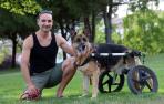 José Mari Martínez posa junto a ‘Nika’, su perra pastor alemán, en un jardín de Barañáin
