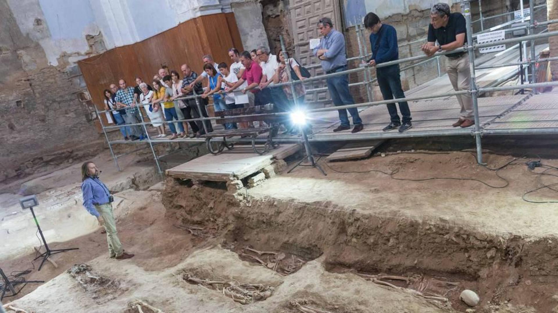 El director de las excavaciones de San Nicolás, Juanjo Bienes -a la izda.-, explica las claves de los trabajos durante una de las visitas.