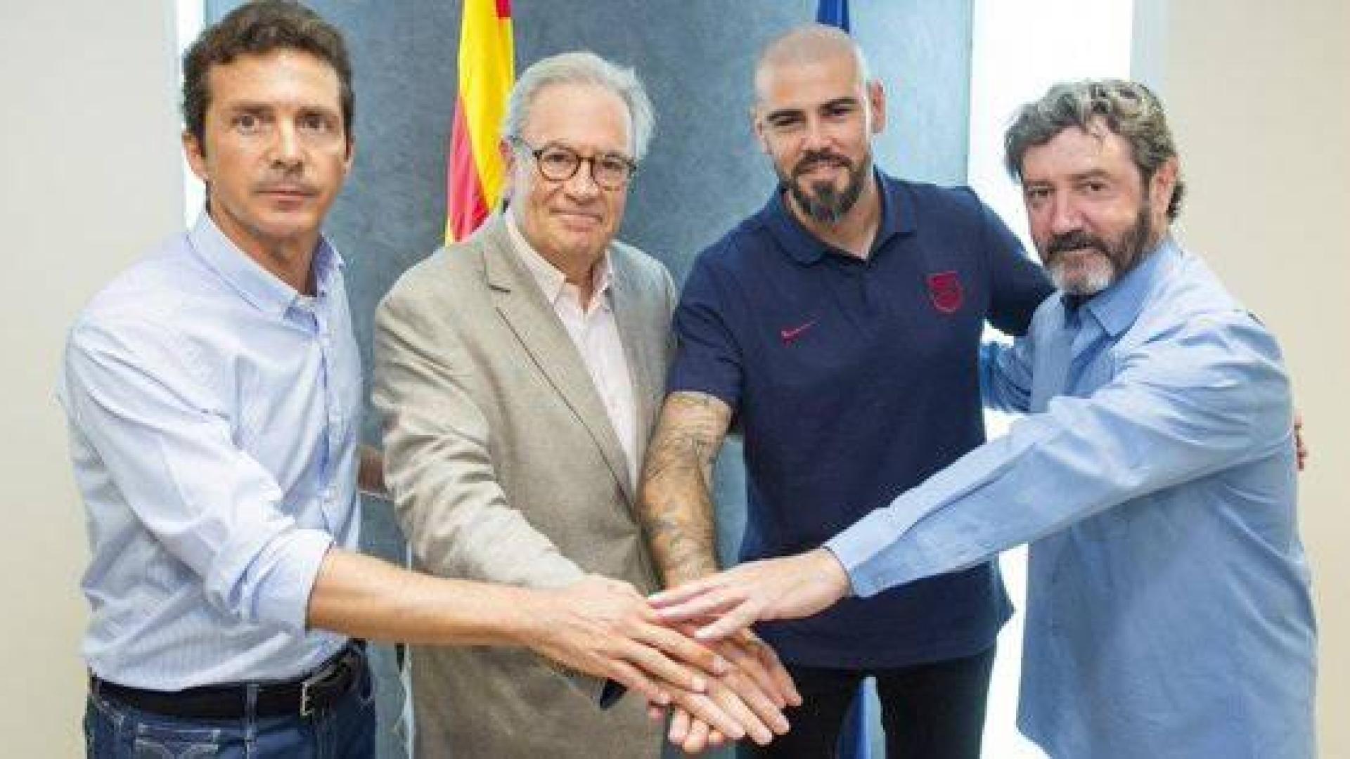 Víctor Valdés, en el centro, tras la firma de su contrato.