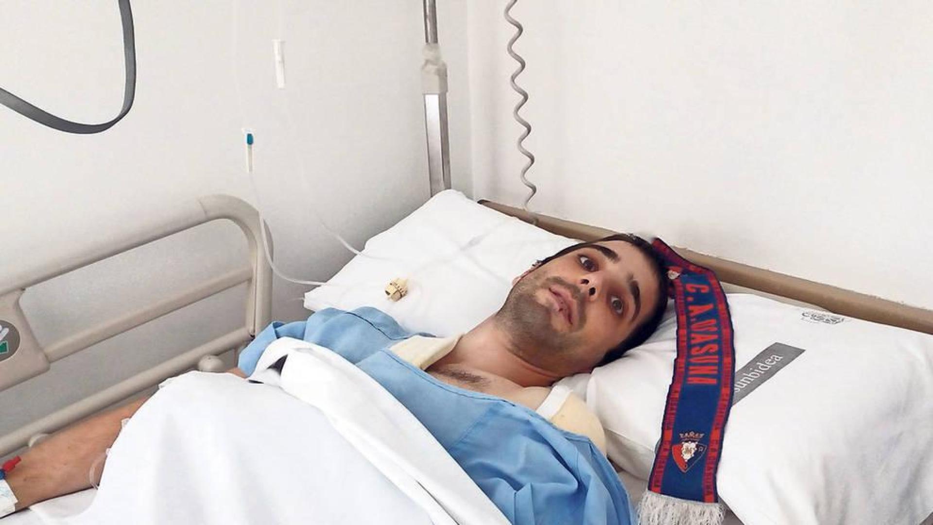 Oihan Górriz Muruzábal, de 26 años, en la habitación del Complejo Hospitalario donde se recupera de las heridas. Junto a él, la bufanda rojilla que tanto ánimo le da