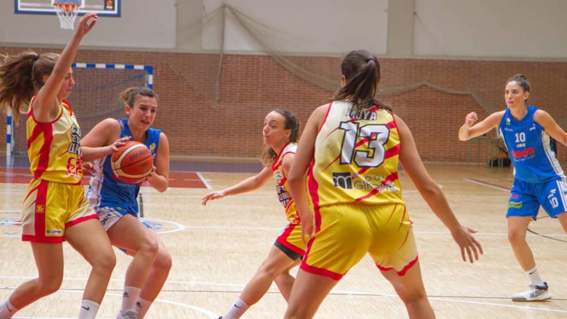 Irantzu Etxeberria trata de avanzar a canasta ante la oposición de tres jugadoras del UniGirona.