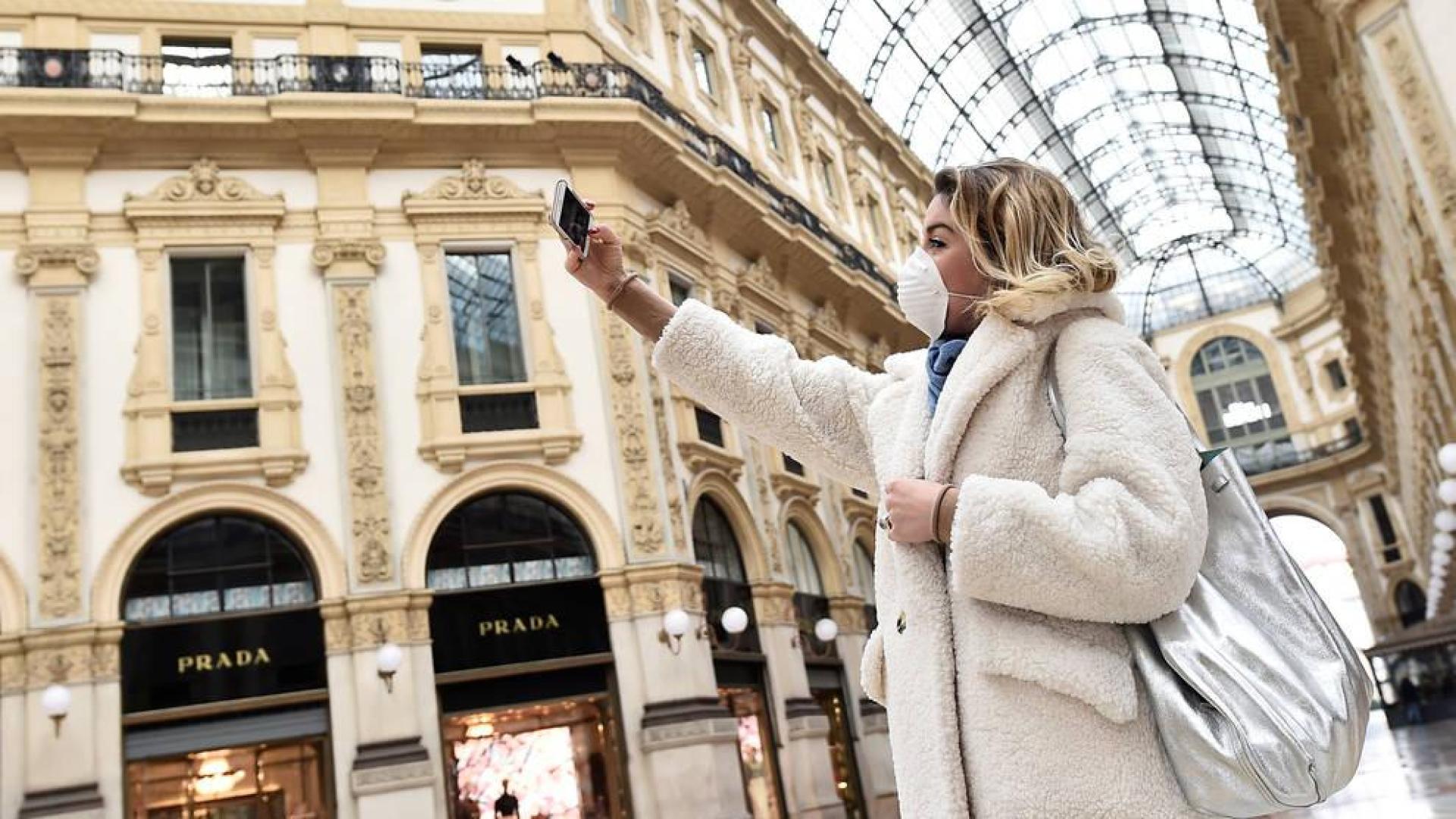 Un persona se fotografía en la mítica Galeria Vittorio Emanuele II de Milán casi desierta por el miedo al coronavirus