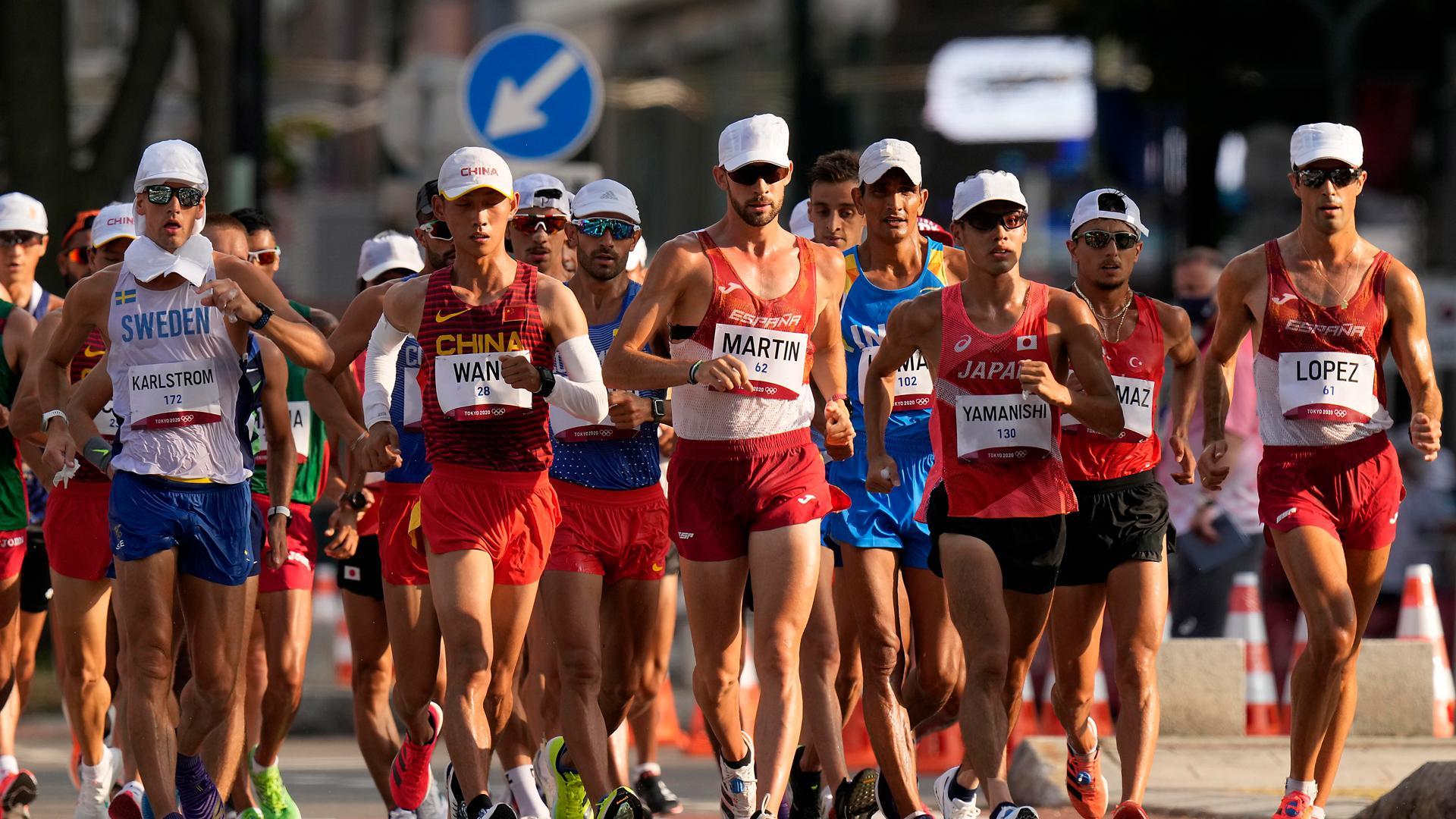 Dos de los marchadores españoles, Alvaro Martín y Miguel Ángel López, en un grupo con otros atletas en la prueba de 20 km marcha de Tokio 2020