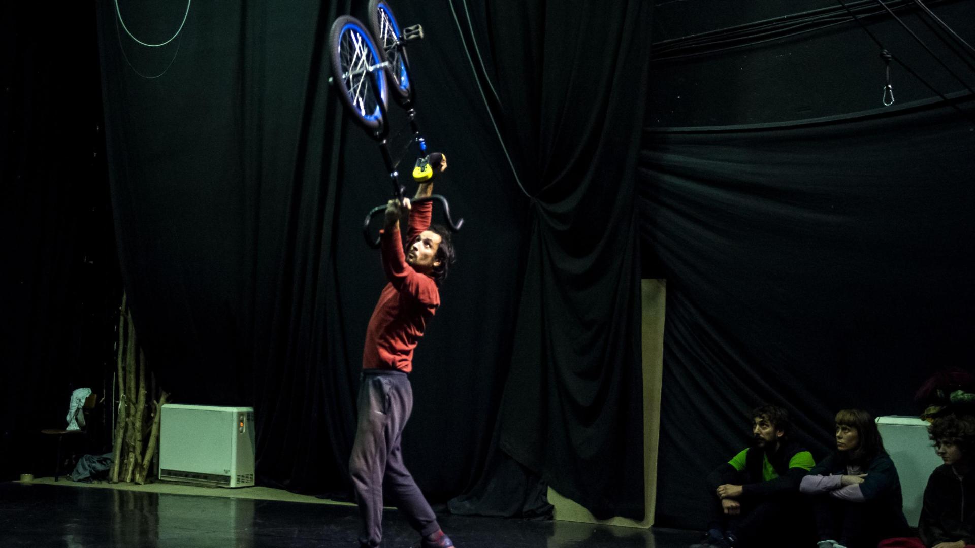 Un artista realiza un número de bicicleta acrobática.