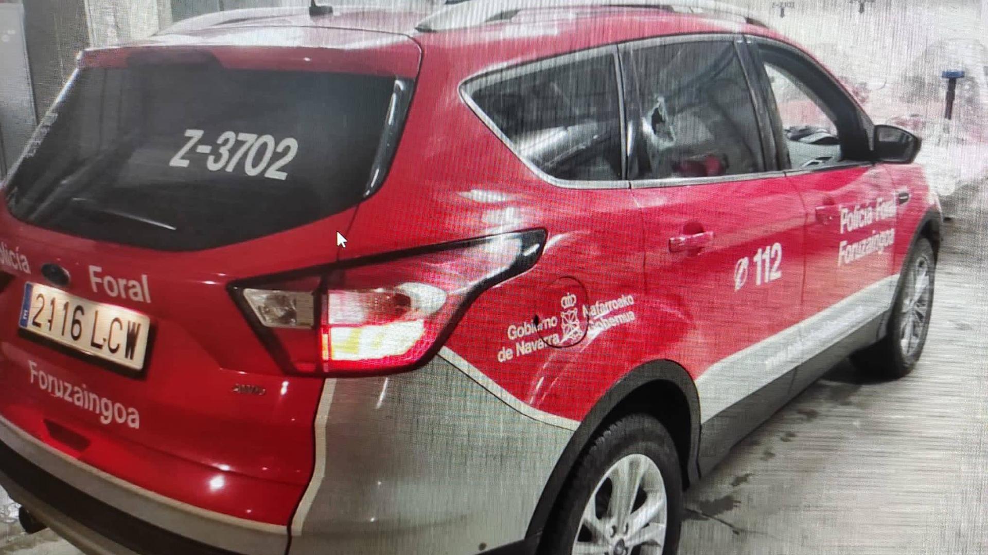 La botella de licor rompió la ventanilla del conductor del coche patrulla y , tras recorrer el habitáculo del vehículo, salió por la ventanilla trasera del copiloto