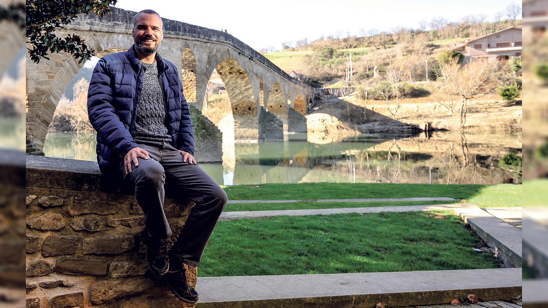 Oihan Mendo, alcalde de Puente la Reina, con el puente románico de fondo