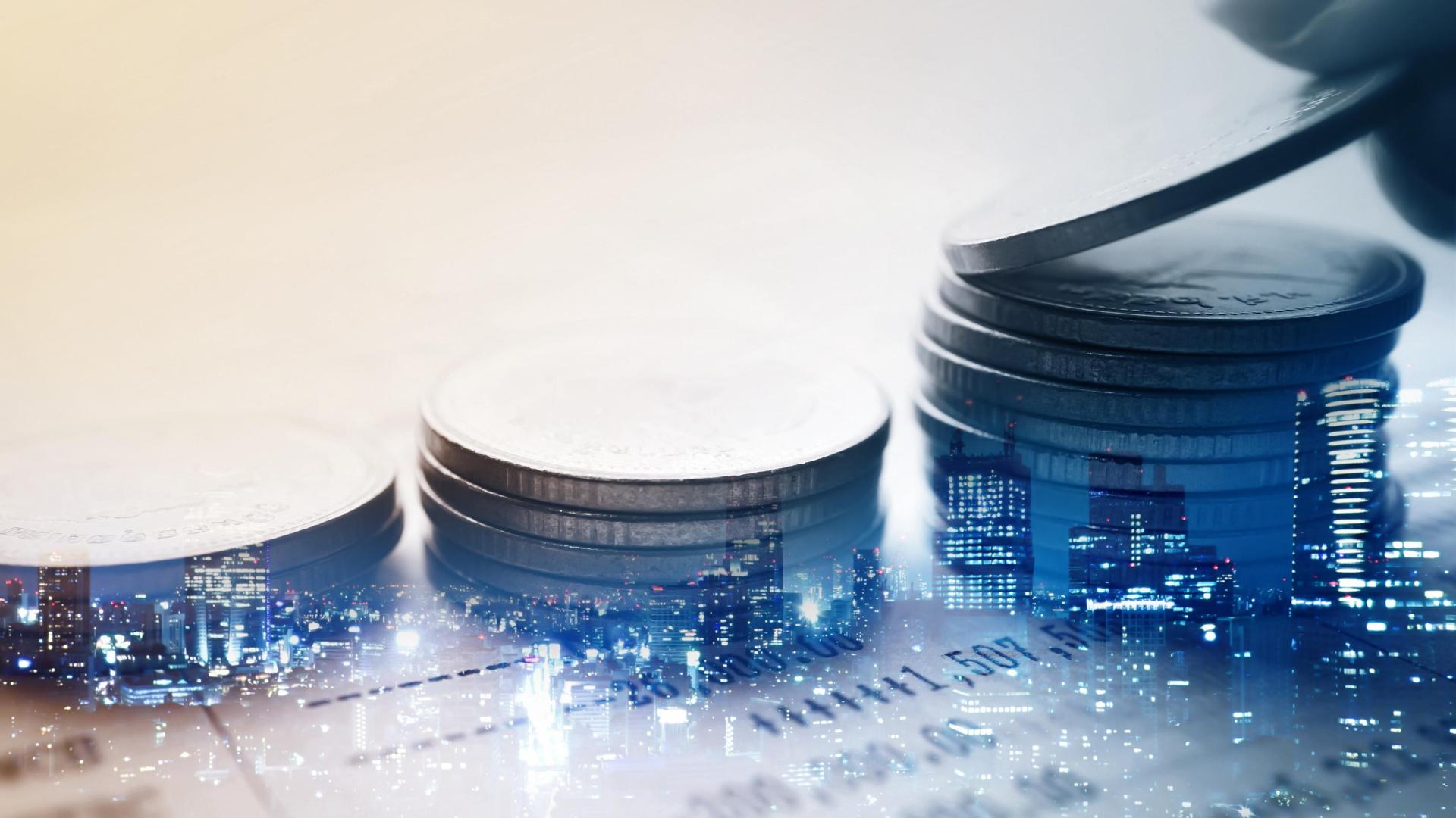Double exposure of city and rows of coins for finance and banking concept